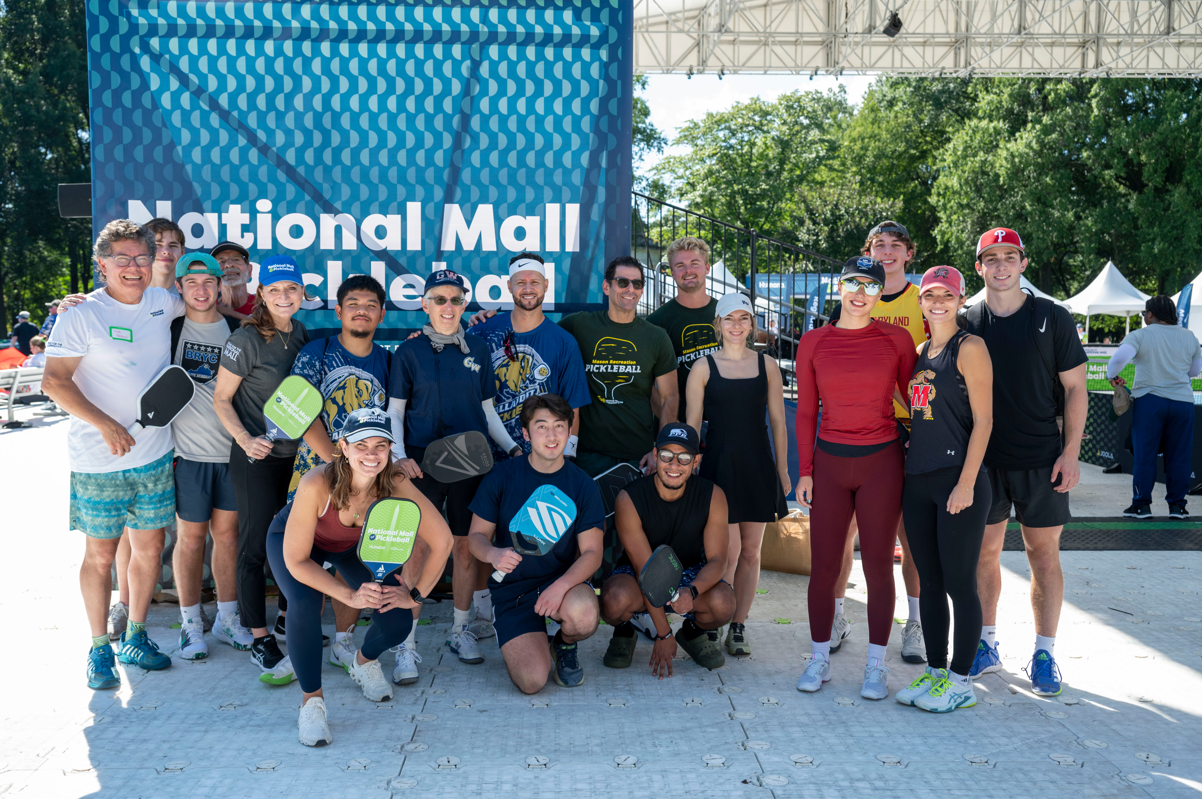 Group shot of picklers in front of Tournament branding.