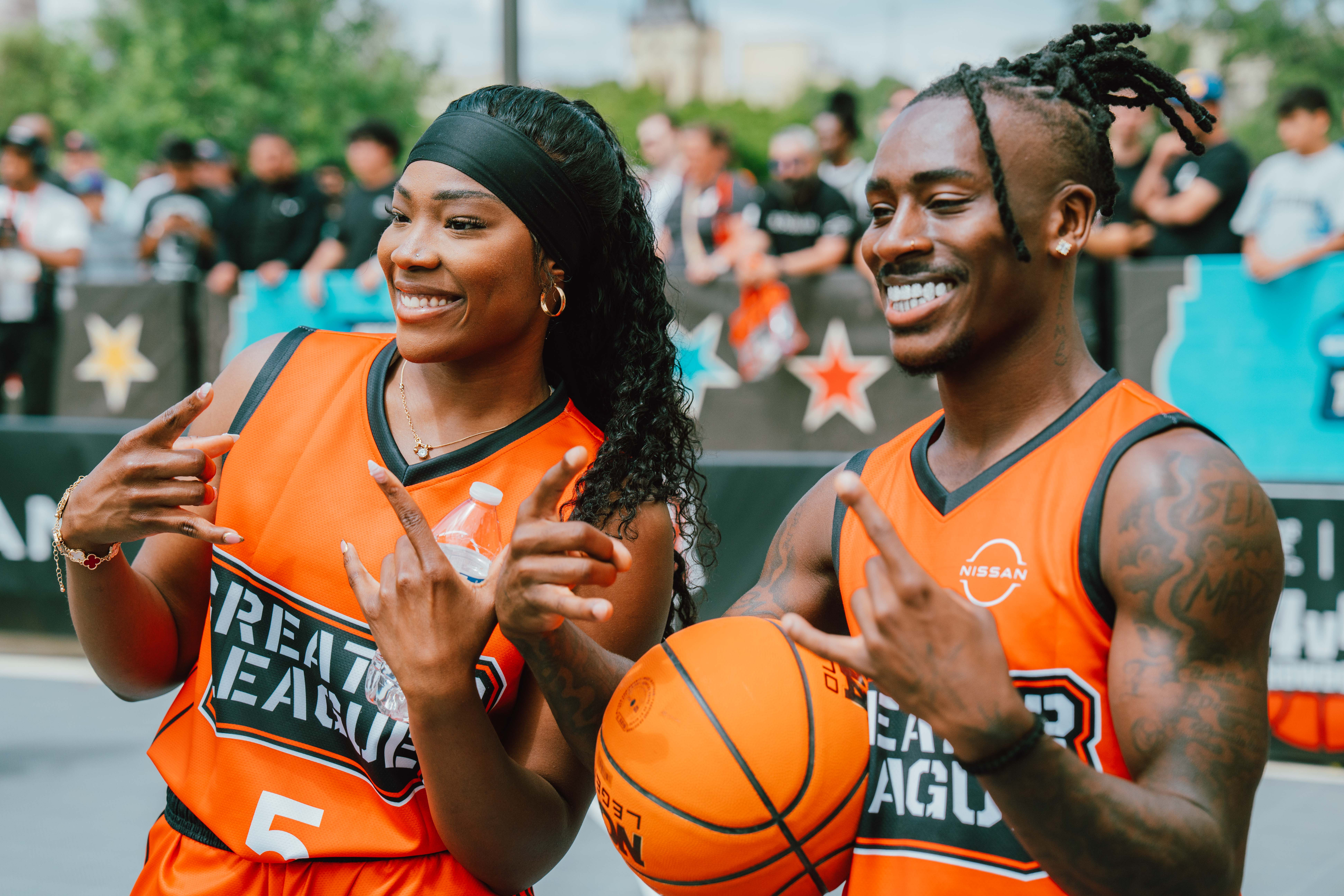 Two creators in basketball gear posing together.