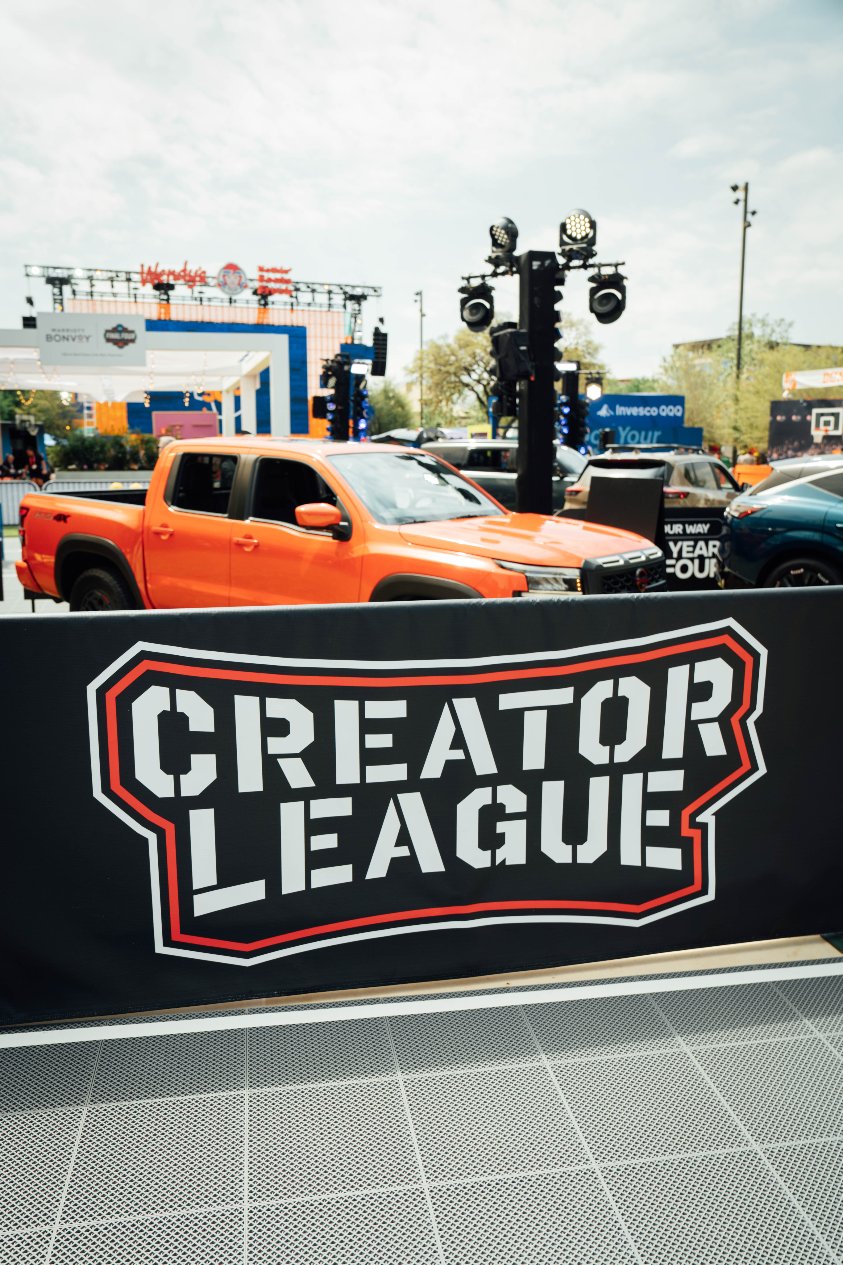 Creator League Banner in front of Nissan truck.