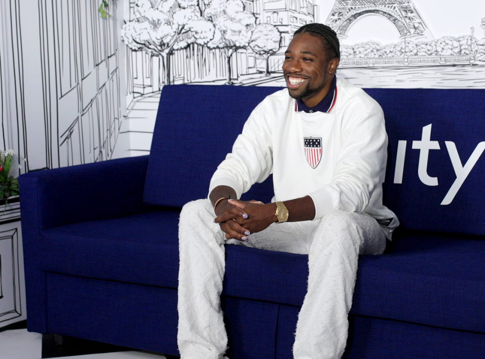 Team USA athlete sitting on couch, smiling 