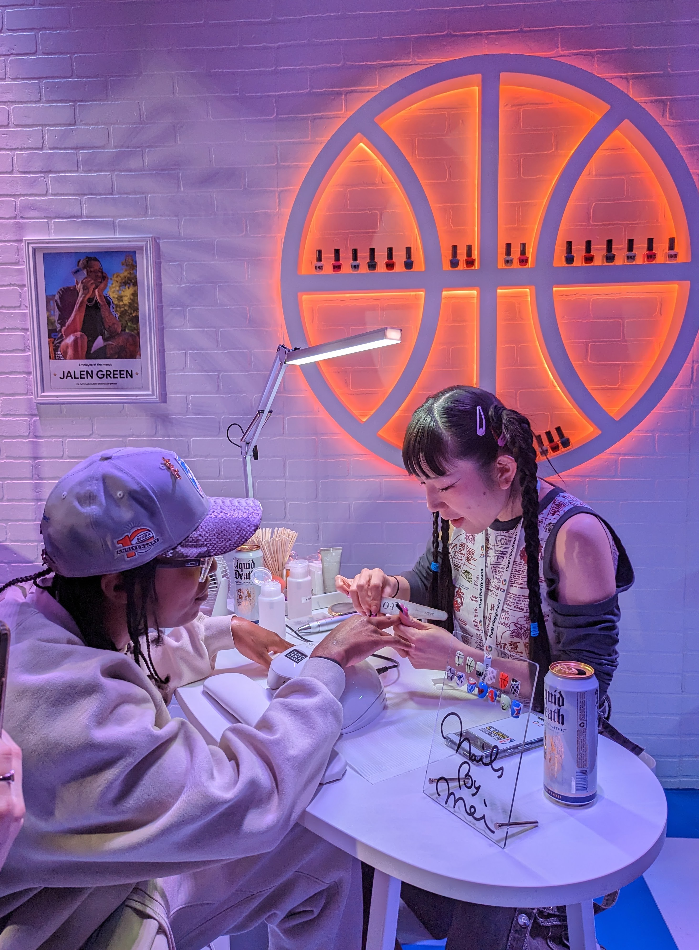 Nail artist working on a fans nails.